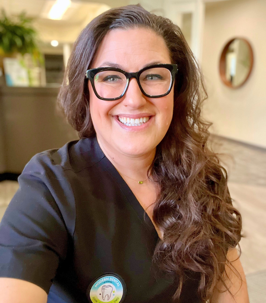 Dental hygienist smiling to represent the friendly and professional team at Modern Dental of Durham