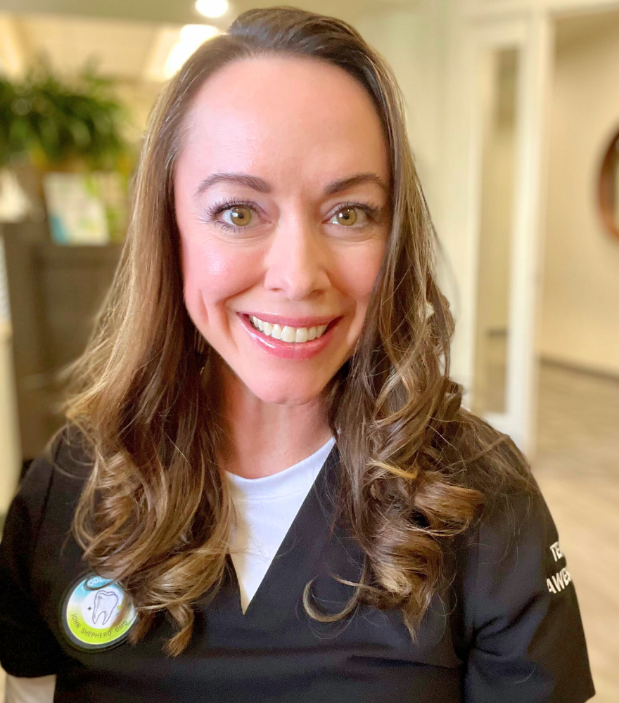 Smiling dental hygienist representing the compassionate, professional team at Modern Dental of Durham