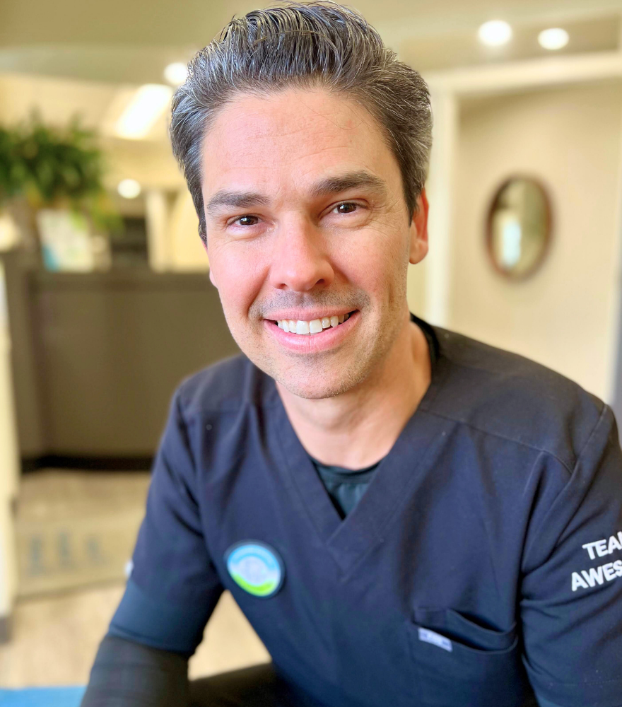 The dentist at ModernDental of Durham smiling