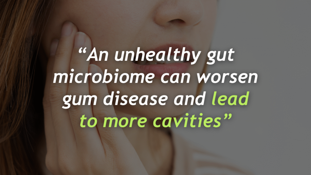 Woman holding her cheek in pain representing how an unhealthy gut microbiome can worsen gum disease and increase risk of cavities